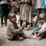Smiling children sitting in a community setting, capturing the essence of childhood joy.
